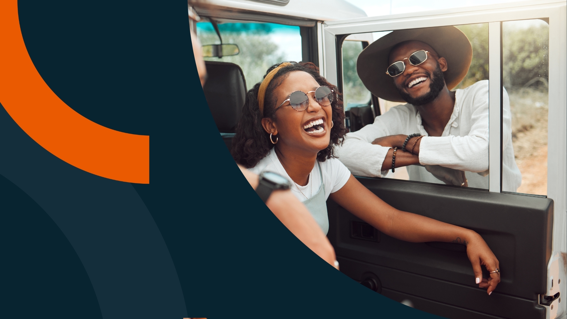 man and woman sitting in a car laughing